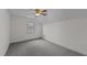 Bedroom featuring gray carpet, white walls, a ceiling fan, and a window for natural lighting at 801 Williamsboro St, Oxford, NC 27565