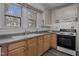This kitchen boasts wood cabinetry, gray counters, and modern appliances at 801 Williamsboro St, Oxford, NC 27565