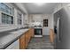 Well-lit kitchen equipped with stainless steel refrigerator, wood cabinets, and gray countertops at 801 Williamsboro St, Oxford, NC 27565