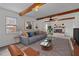 Living room showcasing wooden beam accents, fireplace, and lots of light at 801 Williamsboro St, Oxford, NC 27565