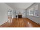 Open living room featuring hardwood floors, a fireplace, and plenty of natural light at 801 Williamsboro St, Oxford, NC 27565