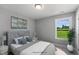 Serene bedroom with a window overlooking a green space and stylish decor at 8701 Maxine St # 43, Willow Springs, NC 27592