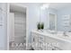 Bright bathroom with double vanity, shower, and bathtub at 71 Priming Way, Angier, NC 27501