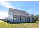 House exterior showcasing a screened porch and landscaping at 71 Priming Way, Angier, NC 27501