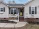 Front entrance with yellow door and brick steps at 10 Alto Ct, Clayton, NC 27520