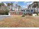 Brick ranch house with blue accents, landscaping, and a fountain in the front yard at 1012 Maple Ave, Apex, NC 27502