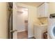 Laundry room features a sink, cabinets, and access to extra storage at 1012 Maple Ave, Apex, NC 27502