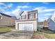 Two-story house with a beige exterior, red shutters, and a two-car garage at 1025 Southgate Dr, Raleigh, NC 27610