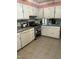 Bright kitchen featuring white cabinets, stainless steel appliances, and tile flooring at 108 Cheney Ct, Garner, NC 27529