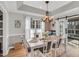 Charming dining room with a white table and chairs, offering access to a deck at 108 Somerset Ct, Mebane, NC 27302