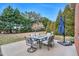 Patio with table, chairs, and umbrella, overlooking backyard at 108 Somerset Ct, Mebane, NC 27302