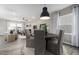 Modern dining area with a black round table and gray cushioned chairs at 1110 Freestone Rd, Durham, NC 27703