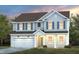 Two-story house with light beige vinyl siding, dark brown roof, and a two-car garage at 1111 Freestone Rd, Durham, NC 27703