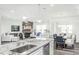 Open concept kitchen with granite island, stainless steel sink, and dishwasher at 1111 Freestone Rd, Durham, NC 27703