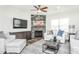 Living area with stone fireplace, ceiling fan, and comfortable seating at 1111 Freestone Rd, Durham, NC 27703
