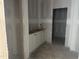 Unfinished laundry room with white cabinets and open doorway at 6842 Galloway Dr, Middlesex, NC 27557