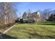 Two-story house exterior with large deck and wooded lot at 115 Birklands Dr, Cary, NC 27518