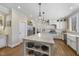 Open kitchen with white cabinets, large island and hardwood floors at 115 Birklands Dr, Cary, NC 27518