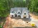 Expansive aerial view of a two-story home showcases its roofline, surroundings, and exterior under construction at 1236 Perry Bluff Dr, Wake Forest, NC 27587