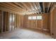 Unfinished basement with exposed beams, window, and studs at 1236 Perry Bluff Dr, Wake Forest, NC 27587