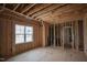 Unfinished bedroom with exposed wood framing, studs, and a window allowing natural light to enter at 1236 Perry Bluff Dr, Wake Forest, NC 27587
