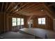 Upstairs bedroom space has multiple windows and wooden framing under construction with drywall stacked in the middle at 1236 Perry Bluff Dr, Wake Forest, NC 27587