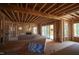 Unfinished living area features wooden framing, fireplace, sliding glass doors to a patio and lots of light at 1236 Perry Bluff Dr, Wake Forest, NC 27587