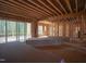 Unfinished living area features wooden framing, fireplace, sliding glass doors to a patio and lots of light at 1236 Perry Bluff Dr, Wake Forest, NC 27587