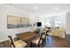 Open dining room with large windows and living room view at 1267 Willow Tree Way, Graham, NC 27253