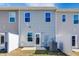Modern townhouse exterior with private patio and fenced yard at 1267 Willow Tree Way, Graham, NC 27253