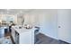 Open concept kitchen with white cabinets and kitchen island at 1267 Willow Tree Way, Graham, NC 27253