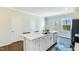 Modern kitchen island with white cabinets and quartz countertops at 1267 Willow Tree Way # 166, Graham, NC 27253