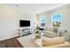 Living room with comfy couch and large windows at 1267 Willow Tree Way, Graham, NC 27253