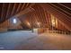 Unfinished attic area with wood beams and window at 1313 Enderbury Dr, Raleigh, NC 27614