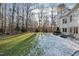 Partially snow-covered backyard with trees at 1313 Enderbury Dr, Raleigh, NC 27614