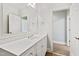 Basement bathroom with white vanity and large mirror at 1313 Enderbury Dr, Raleigh, NC 27614