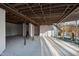 Unfinished basement with high ceilings, concrete floors, and a wooden staircase at 1313 Enderbury Dr, Raleigh, NC 27614