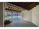 Unfinished basement area with access to the backyard and a wood pile at 1313 Enderbury Dr, Raleigh, NC 27614