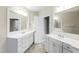 Double vanity bathroom with a large mirror and tile flooring at 1313 Enderbury Dr, Raleigh, NC 27614