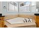 Bathroom with corner soaking tub and tile surround at 1313 Enderbury Dr, Raleigh, NC 27614