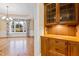 Butlers pantry with wooden cabinets, glass doors, and drawers at 1313 Enderbury Dr, Raleigh, NC 27614