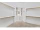 Large walk-in closet with built-in shelves, drawers and hanging rods at 1313 Enderbury Dr, Raleigh, NC 27614