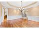 Spacious dining room with hardwood floors, chandelier, and views to staircase and kitchen at 1313 Enderbury Dr, Raleigh, NC 27614