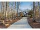 Long driveway leading to a charming home nestled in woods at 1313 Enderbury Dr, Raleigh, NC 27614