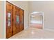 Elegant entryway with double wood doors, stained glass, and view to formal dining room at 1313 Enderbury Dr, Raleigh, NC 27614