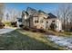 Stone and stucco home with landscaping and driveway at 1313 Enderbury Dr, Raleigh, NC 27614