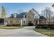 Elegant two-story home with stone accents and a large driveway at 1313 Enderbury Dr, Raleigh, NC 27614