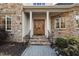 Inviting entryway with stone facade and wood door at 1313 Enderbury Dr, Raleigh, NC 27614