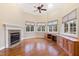 Bright home office features hardwood floors, built-in cabinetry, fireplace, and large windows at 1313 Enderbury Dr, Raleigh, NC 27614