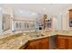 Kitchen with granite countertops, island, and view into Gathering room at 1313 Enderbury Dr, Raleigh, NC 27614
